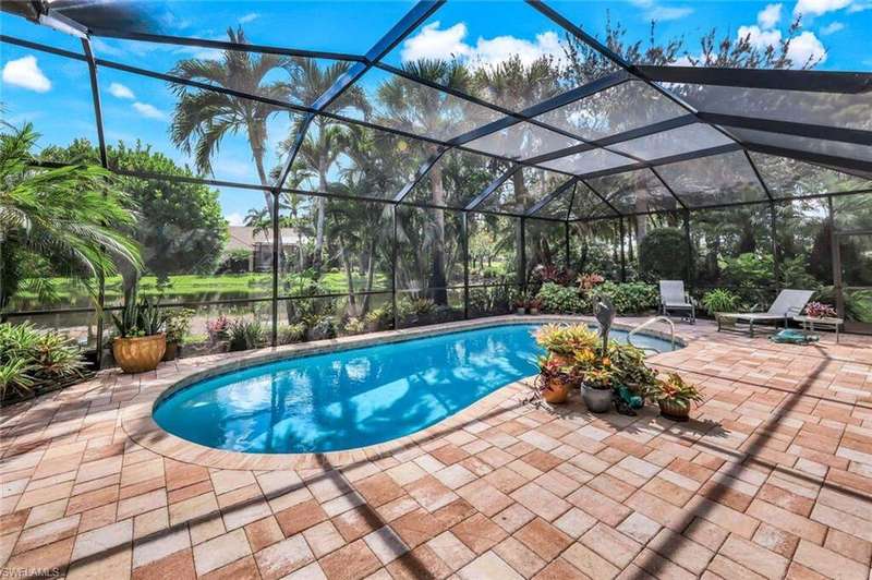 Swimming pool with a lanai, a water view, a sunroom, and a patio area