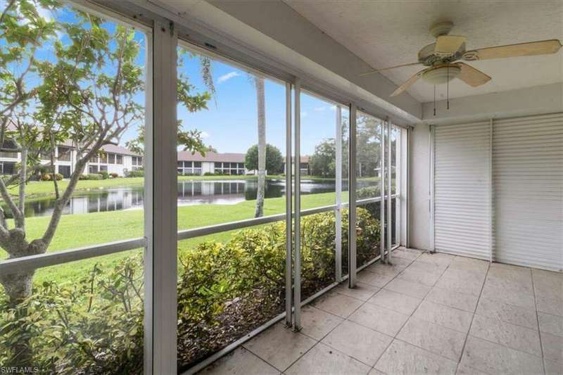 Unfurnished sunroom with a water view and ceiling fan