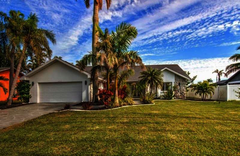 View of front of home featuring a garage and a front lawn