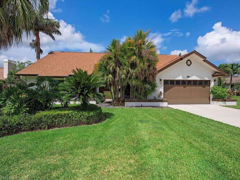 Mediterranean / spanish-style home featuring a garage, a front yard, driveway, roof with shingles, and stucco siding