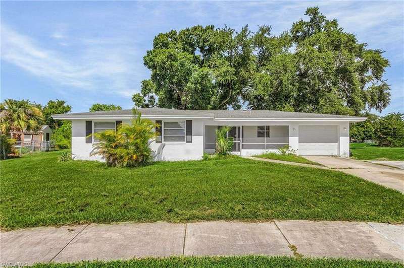 Ranch-style home featuring a garage and a front yard