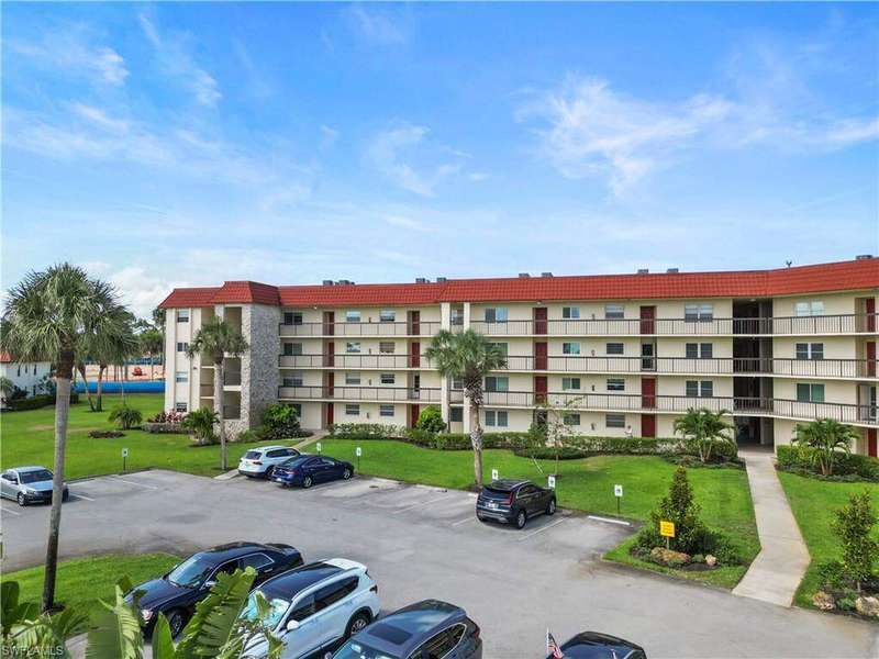 View of Par One Condo building 2 featuring uncovered parking