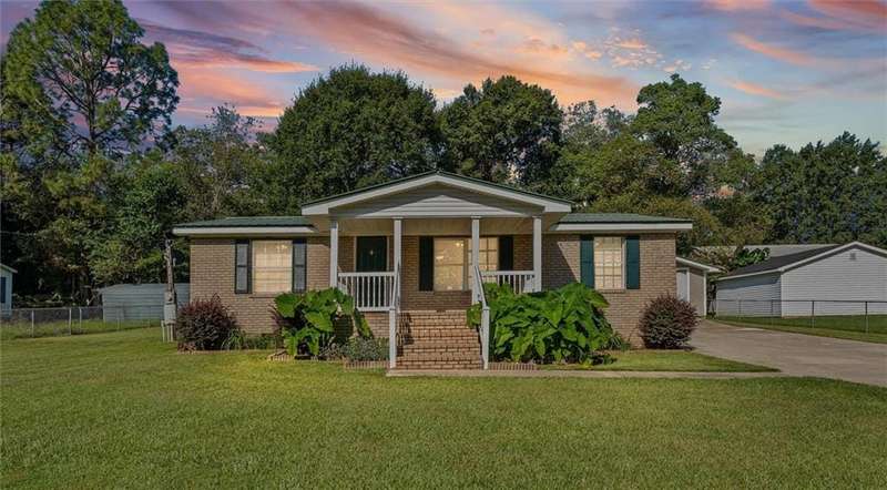 Bungalow-style home featuring brick siding and covered porch