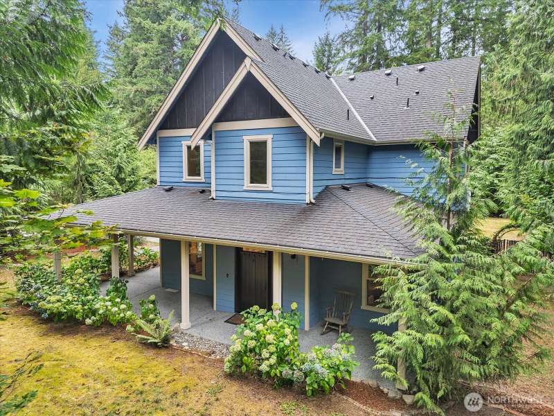 The front of the house looking from the West. Covered porch on the North 1/2 of the house, as well.
