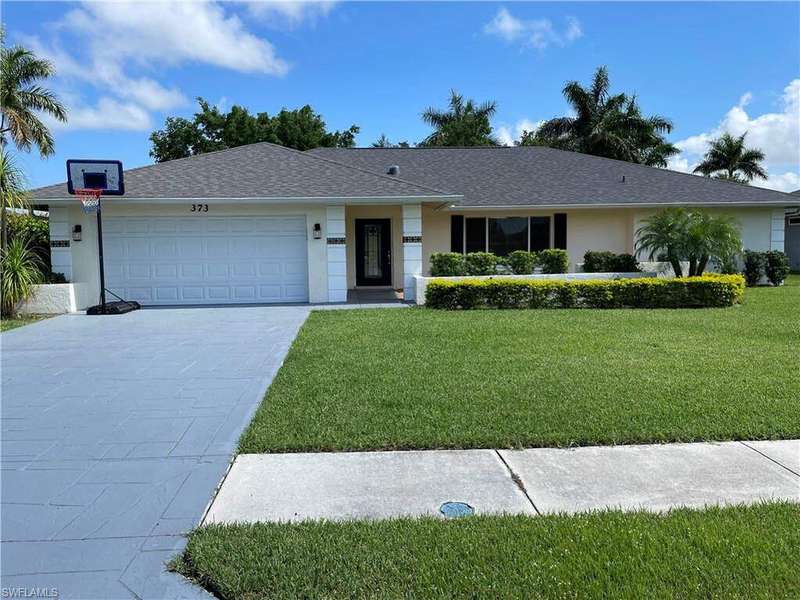 Ranch-style home featuring a garage and a front yard