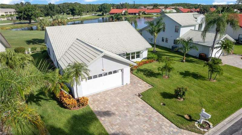 View of patio / terrace with a fire pit, grilling area, an outdoor kitchen, and a water view