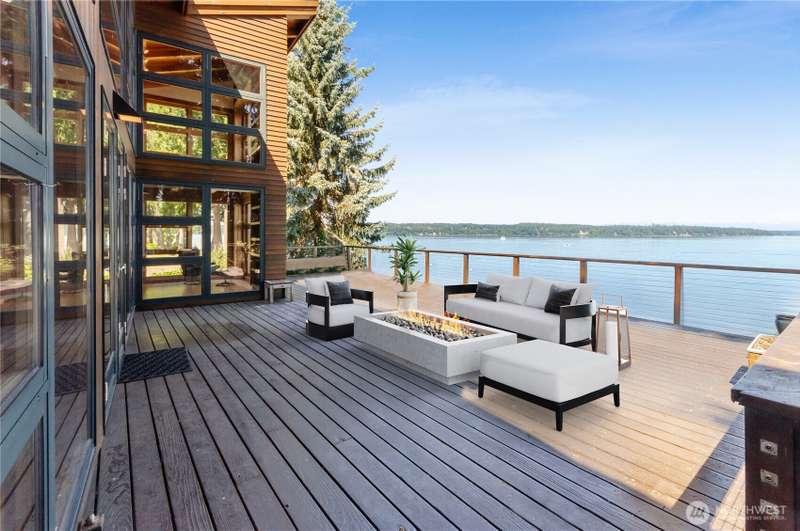 Experience coastal living at its finest in this stunning NW Contemporary on Johnson Point! Enjoy sweeping Puget Sound views with Harstine Island to the south, Longbranch to the north, and breathtaking sunsets over the Olympic Range through a wall of west-