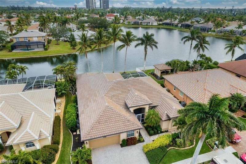 Aerial perspective of suburban area featuring a nearby body of water