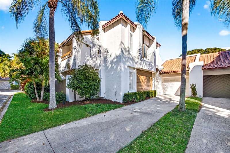 View of front of property with stucco siding, a ti