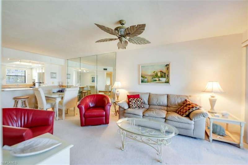 Living room featuring carpet and ceiling fan
