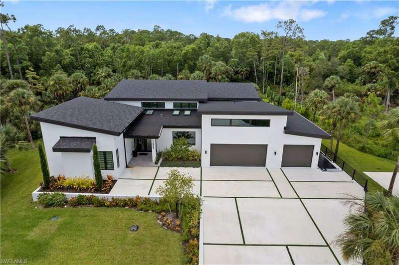 Modern home featuring a garage and a front yard