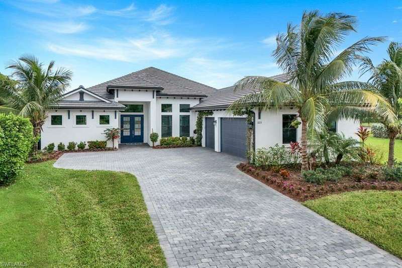 View of front of house with a front yard and a garage