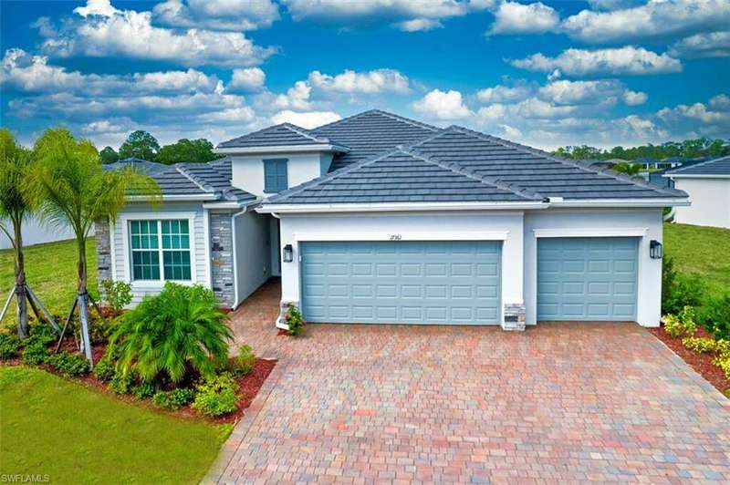 View of front of house with a front lawn and a garage