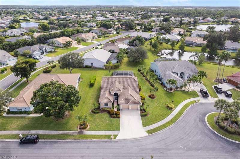 Aerial view of property's location featuring nearby suburban area and a large body of water