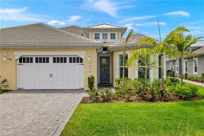 View of front of house with a garage and a front yard