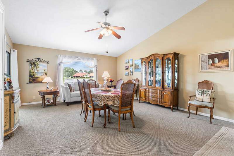 Aerial perspective of suburban area with a golf club and a large body of water
