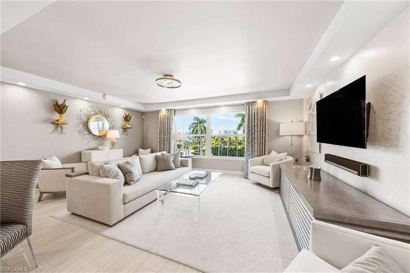 Living area featuring recessed lighting and a tray ceiling