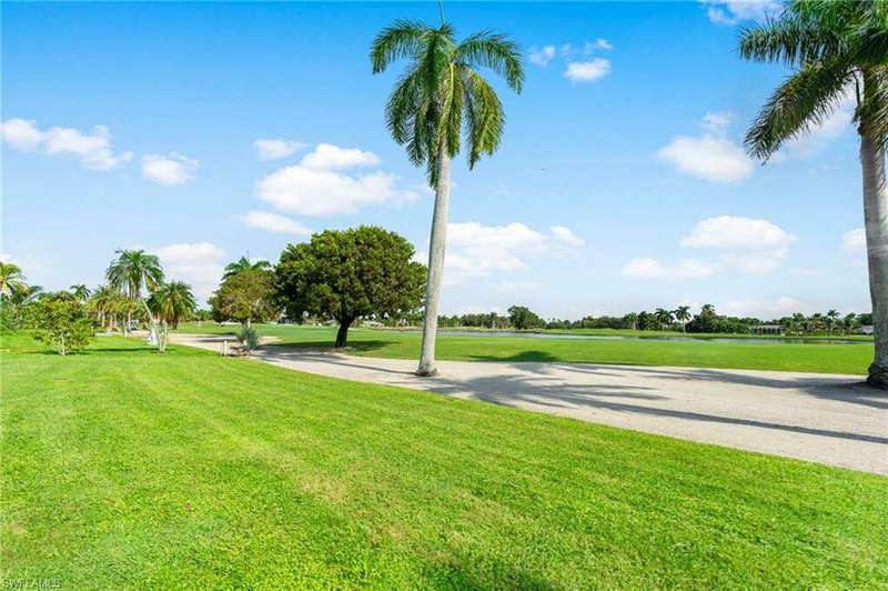 View of property's community with a lawn