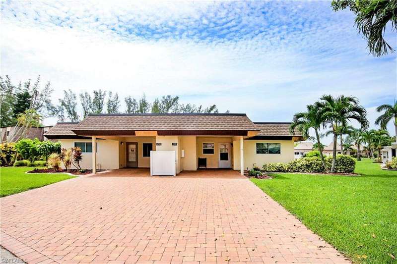 Ranch-style home with a front lawn and a carport
