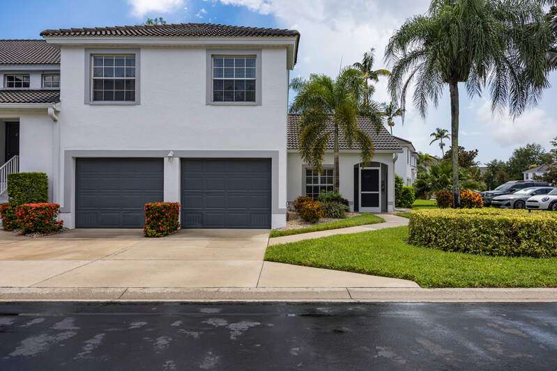 Mediterranean / spanish home featuring an attached garage, a front yard, driveway, and stucco siding