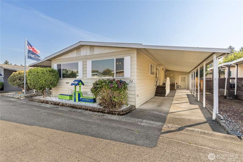 Welcome home! 2-Car tandem carport with large storage room in the back.