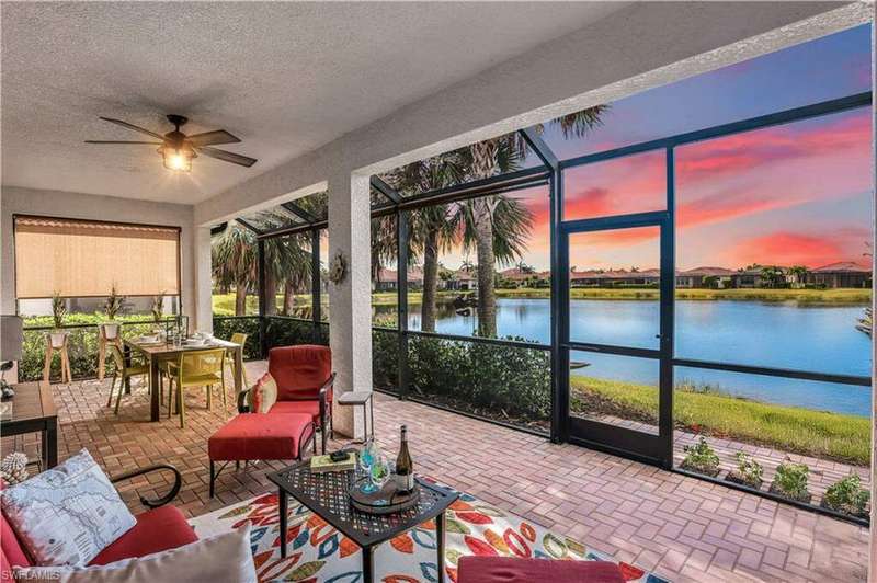 Sunroom with a water view and ceiling fan