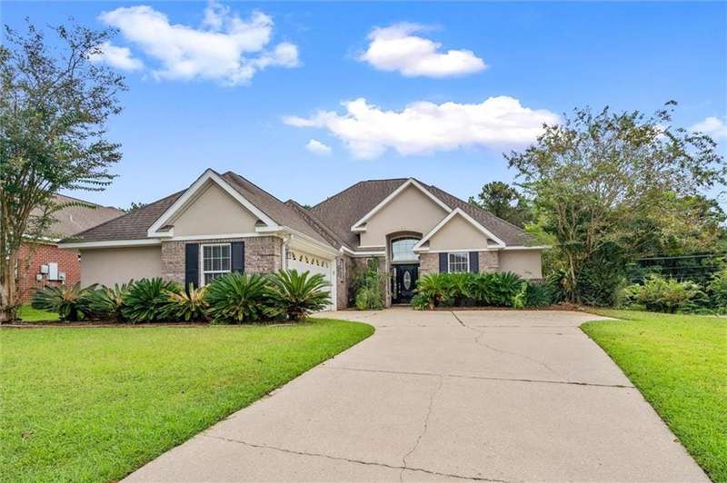 Ranch-style home with a garage and a front yard