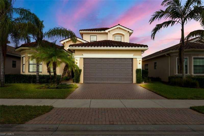 Mediterranean / spanish house with a front yard and a garage