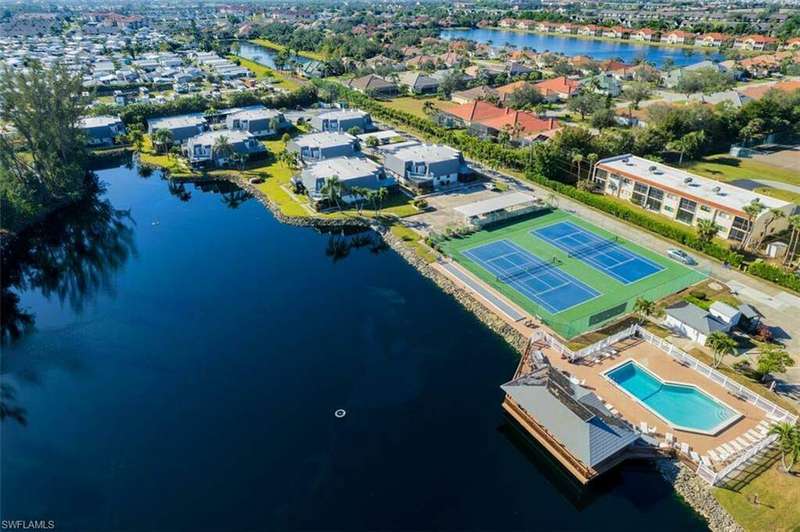 Birds eye view of property with a water view