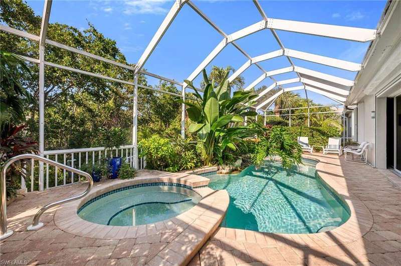 Screened-in pool and spa with paver surrounds.  This home is protected with hurricane protection for whole house.