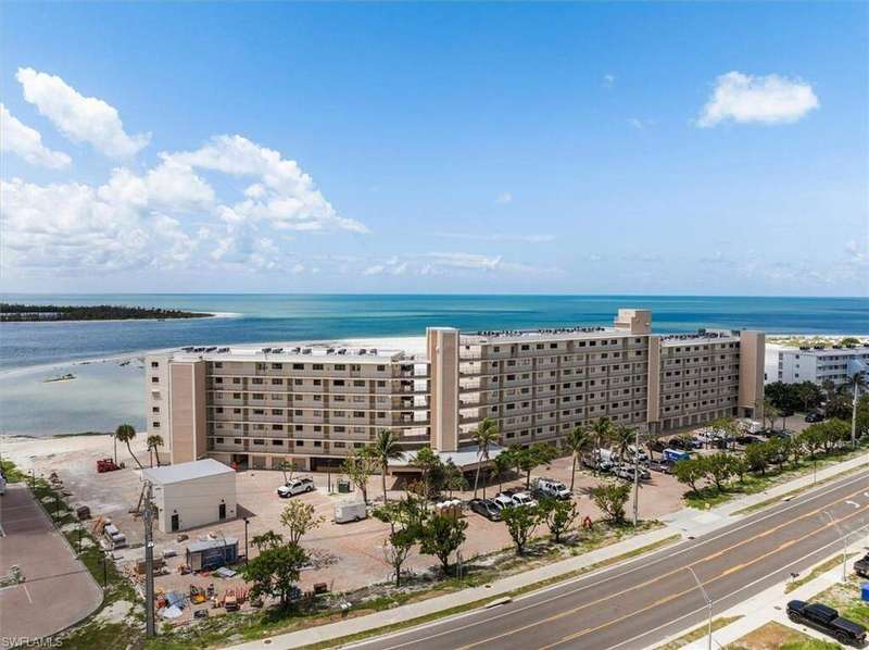 Bird's eye view of apartment complex and a nearby body of water