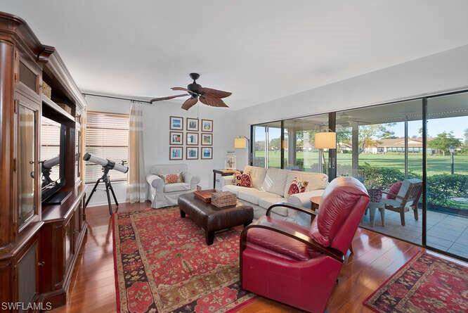 Living room featuring ceiling fan and hardwood / wood-style flooring