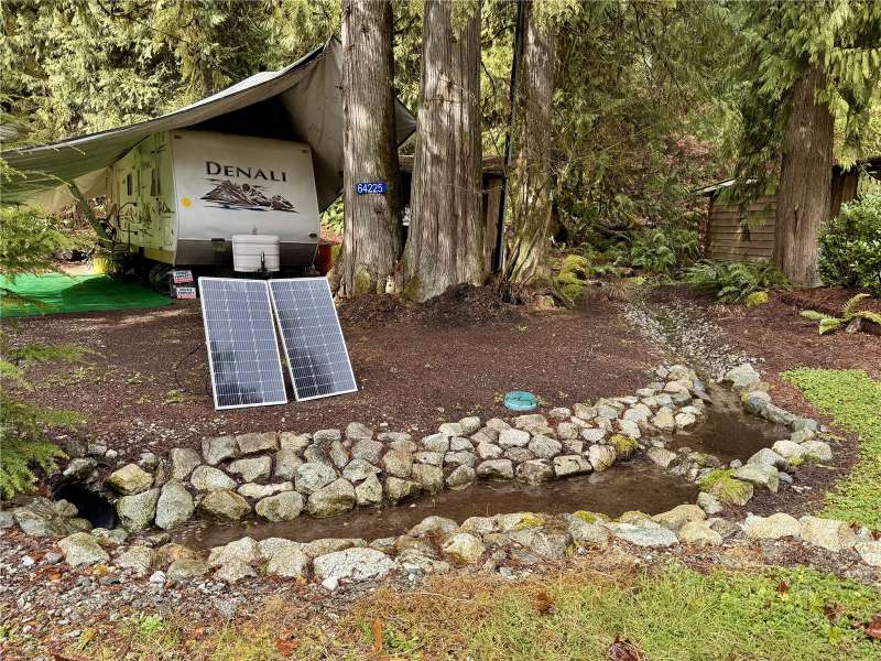 Nicely landscaped lot with trailer.