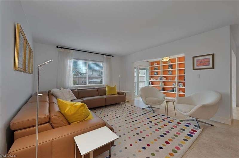 Living room featuring a chandelier, light tile patterned flooring, and recessed lighting