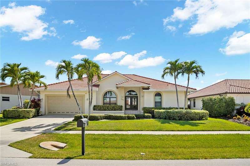 Mediterranean / spanish-style home featuring a front yard and a garage