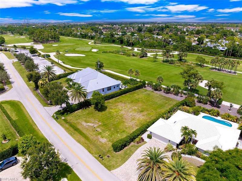 Aerial view of residential area with a golf club and a tree filled landscape