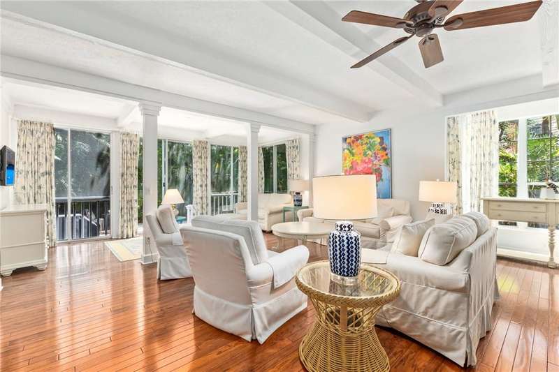 Living room featuring beam ceiling, hardwood / woo