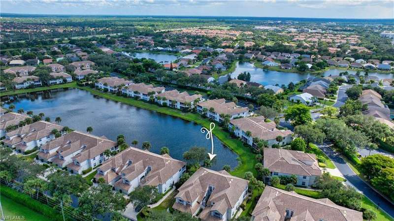 Aerial view of property and surrounding area featuring a lake views