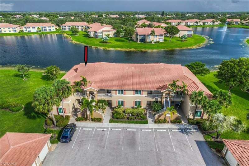 Birds eye view of property with a water view