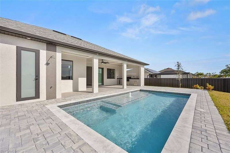 View of pool with ceiling fan, a patio area, and a fenced backyard