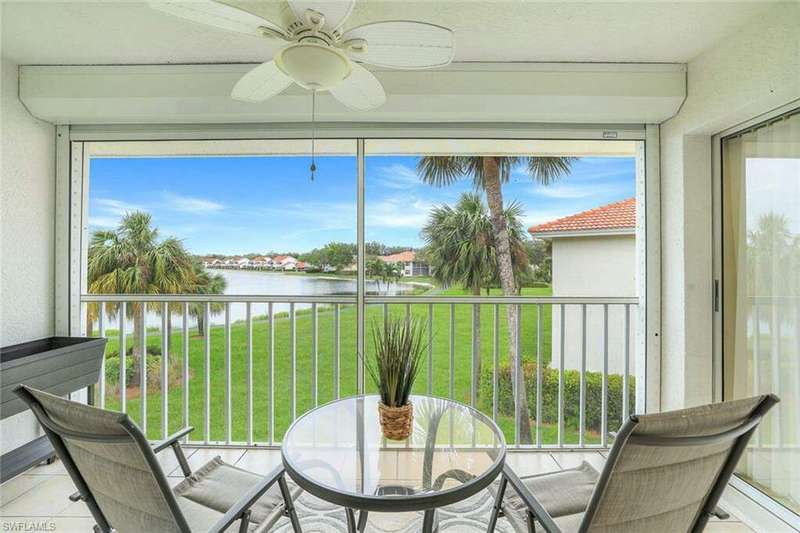 Sunroom / solarium with a water view and ceiling fan