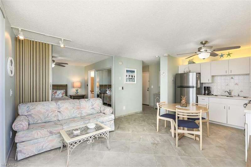 Kitchen with stainless steel appliances, sink, light tile patterned floors, a textured ceiling, and ceiling fan