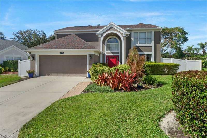 Front facade of home with lawn and two-car attached garage