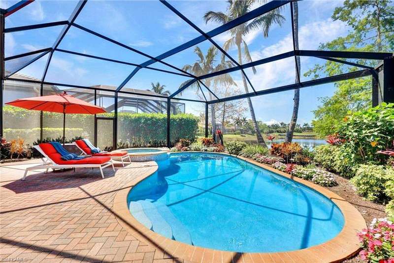 View of pool featuring a pool with connected hot tub, a water and golf course view, new picture frame lanai cage.
