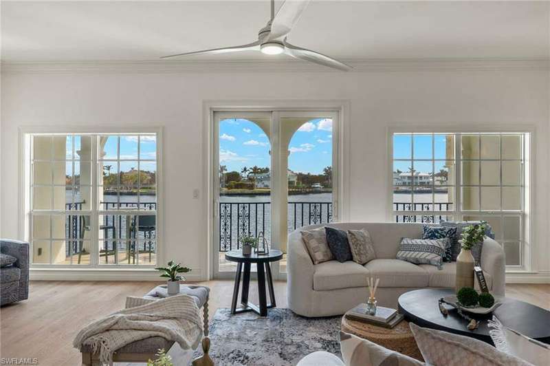 Virtually staged Great Room with hardwood floors and eastern view of Venetian Bay.