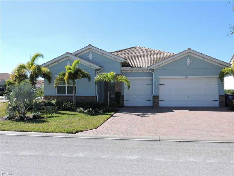 View of front facade with a garage and a front lawn