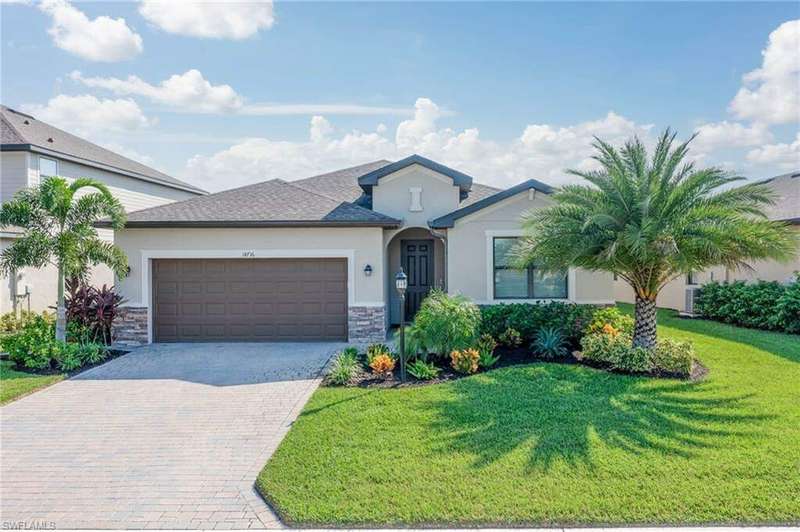 View of front of home with a front yard and a garage