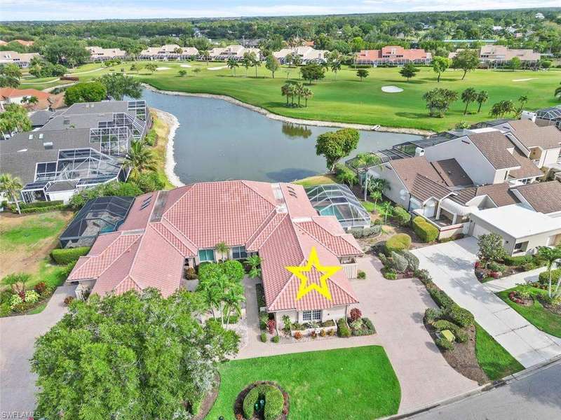 Aerial perspective of suburban area with a golf club and a large body of water