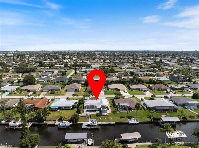 View of property location featuring a large body of water and nearby suburban area