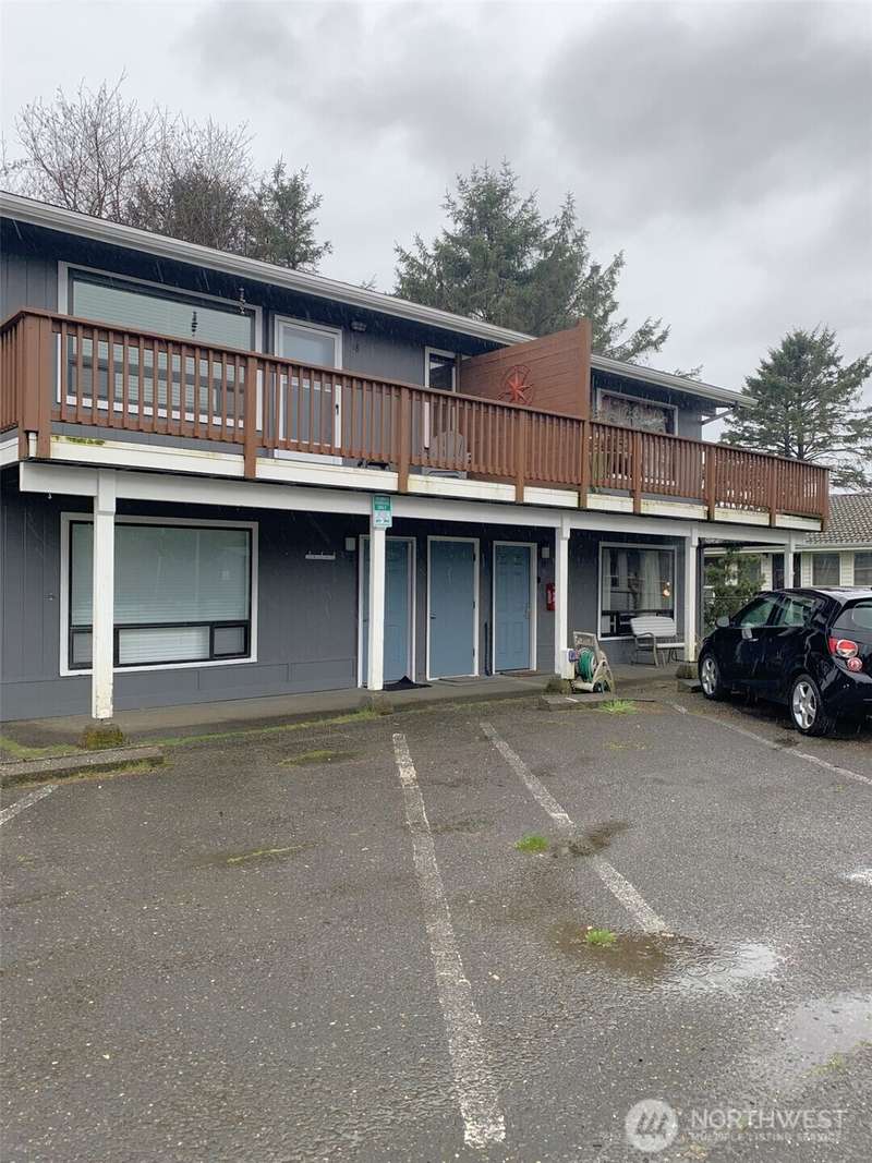 The middle door leads to the unit.  The parking spot is the empty one to the right in this photo.  It's marked '20', but it's hard to read.